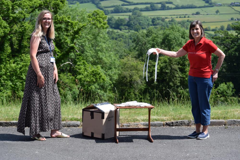 Bea giving a box of white masks to Becci, who works for Mind Cymru. Bea giving a box of white masks to Becci, who works for Mind Cymru.
